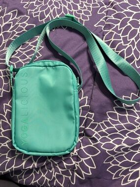 This is a teal Yogalicious nylon crossbody bag.